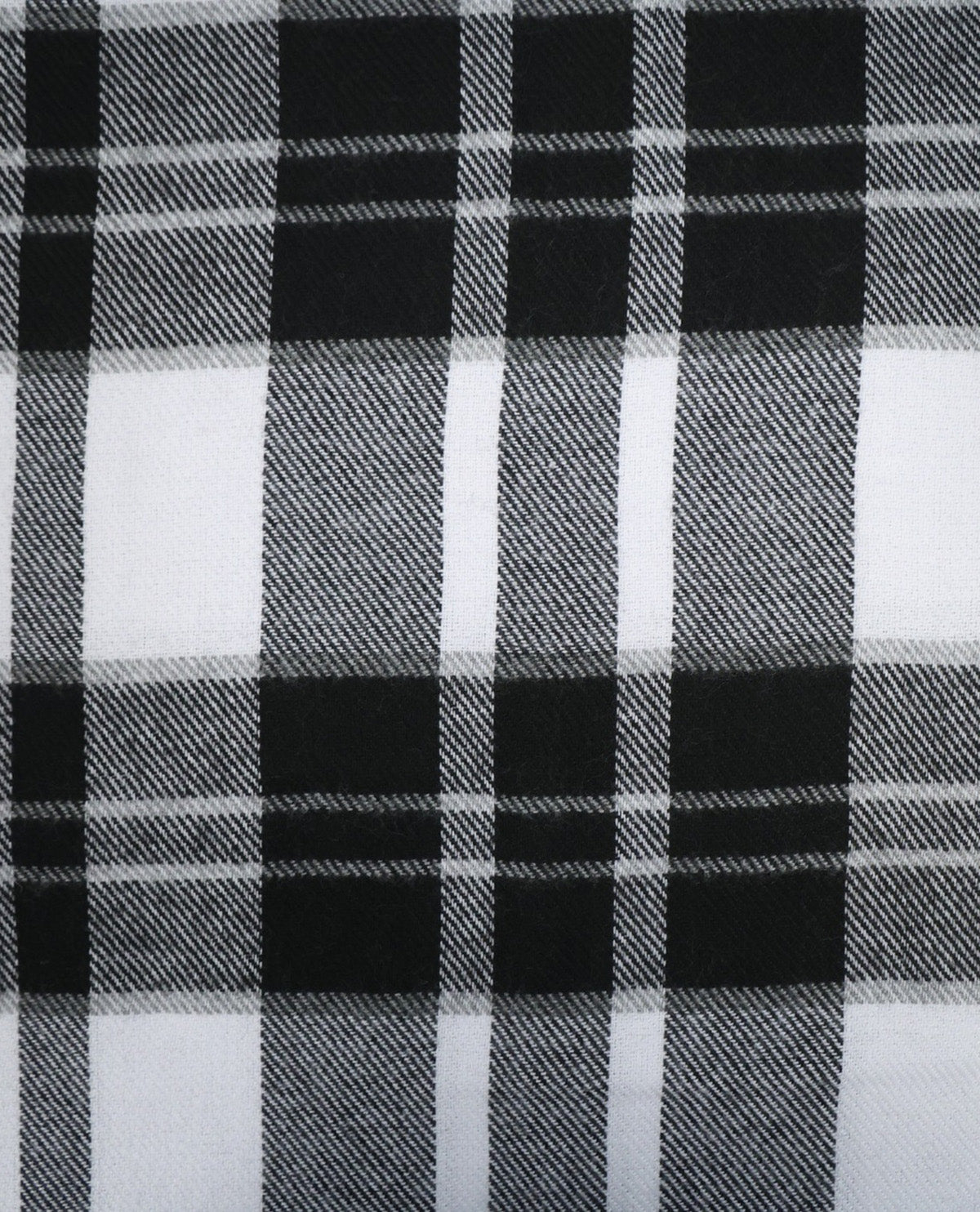 Black and white plaid fabric pattern close-up showing a woven tartan design with alternating black, white, and gray blocks.