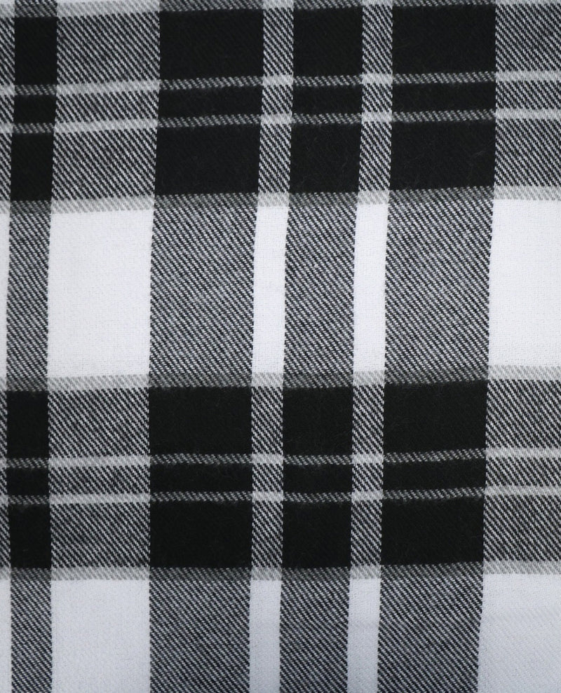 Black and white plaid fabric pattern close-up showing a woven tartan design with alternating black, white, and gray blocks.