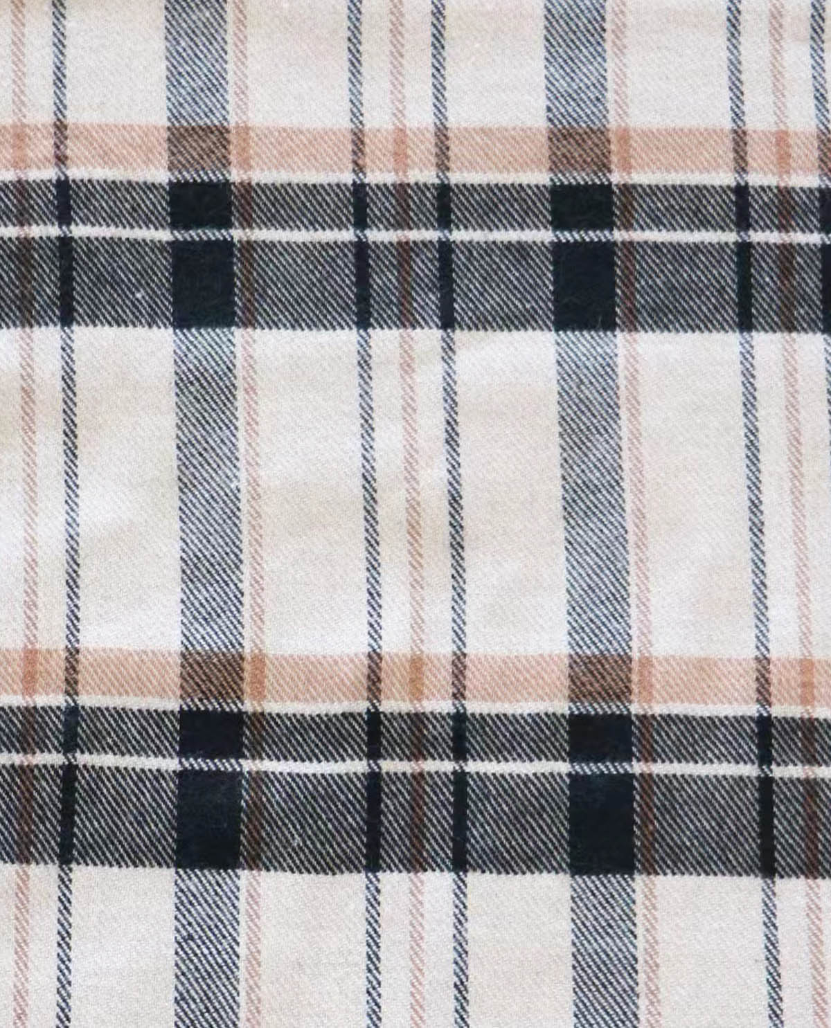 Close-up of a plaid fabric with black, white, and beige colors.