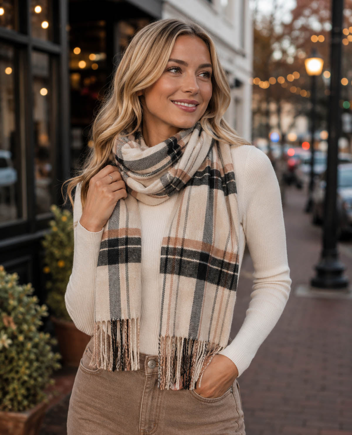 Woman wearing a plaid scarf on a city street