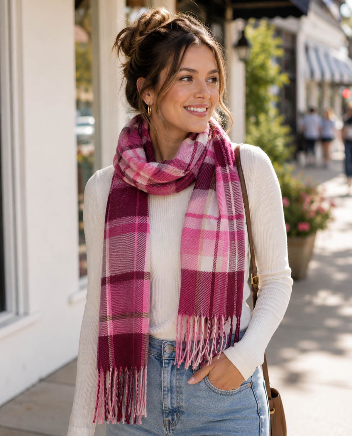 Woman wearing a pink plaid scarf on a street
