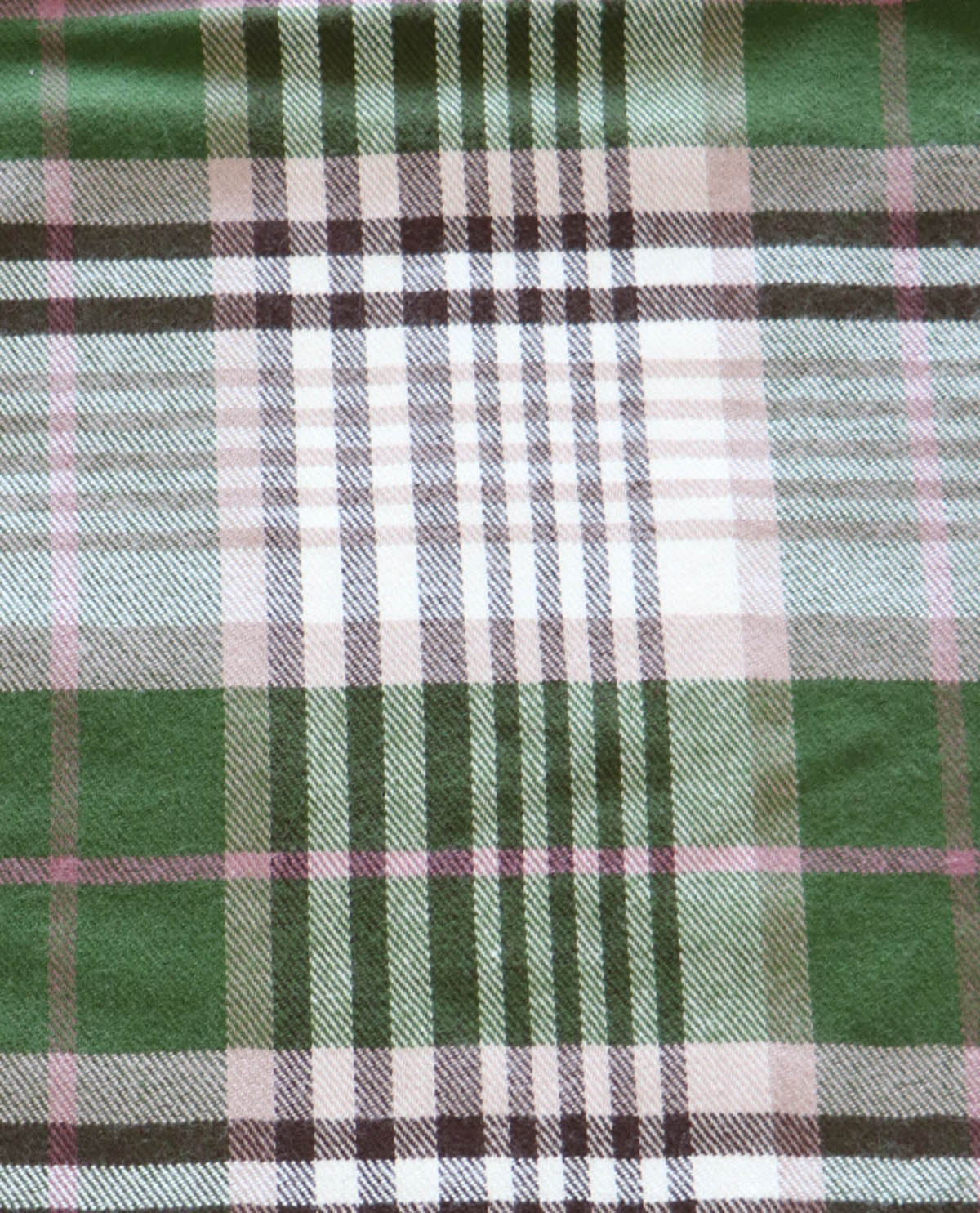 Close-up of green plaid fabric with a visible texture