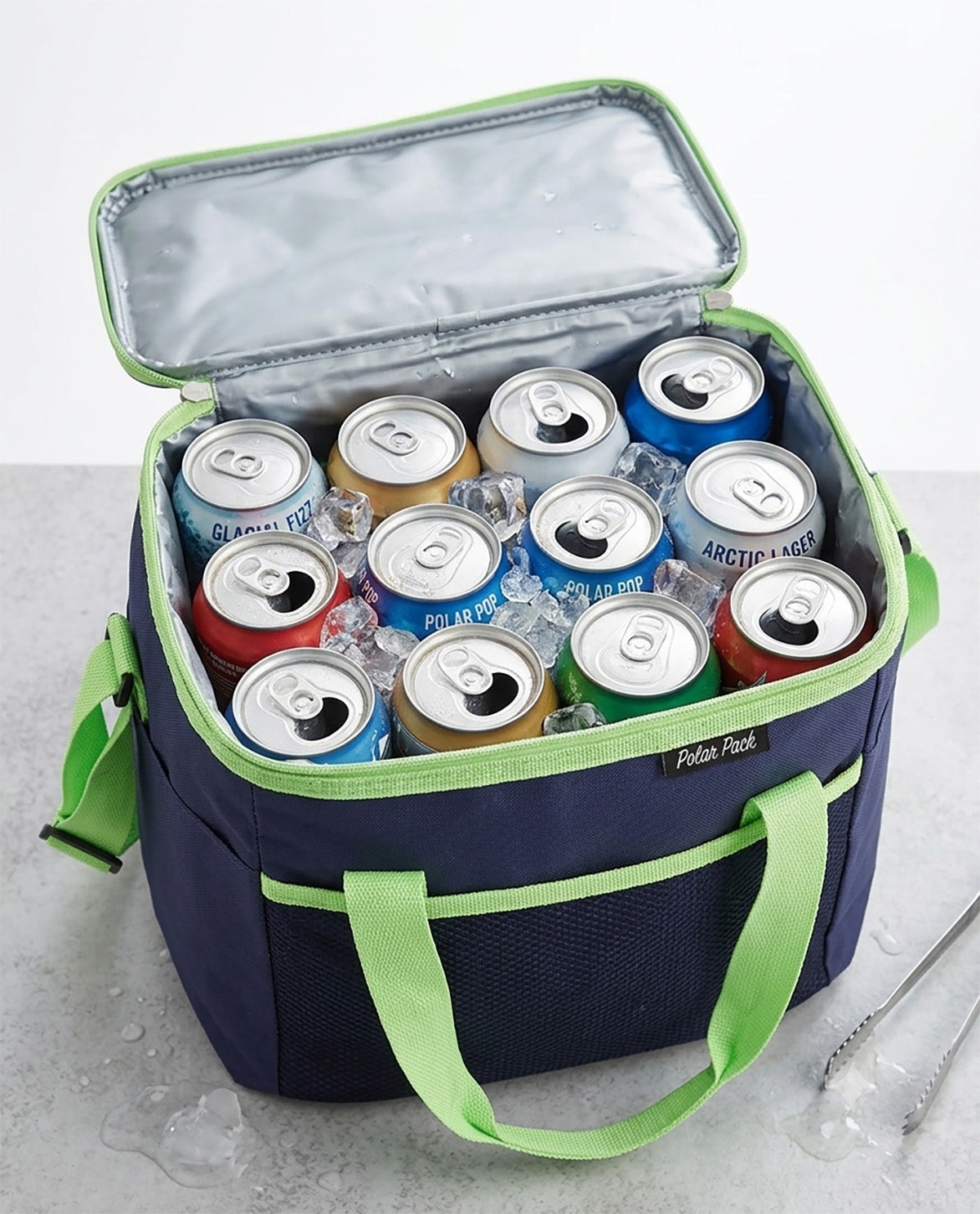 A navy blue cooler bag with lime green handles and trim, shown open and filled with assorted canned sodas and iced drinks on a light gray surface. The cooler has a visible 'Polaroid' brand label on the front.
