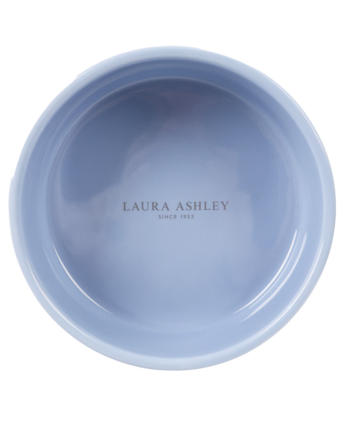 A top-down view of a light blue ceramic bowl with 'LAURA ASHLEY SINCE 1965' printed in the center, on a solid white background.
