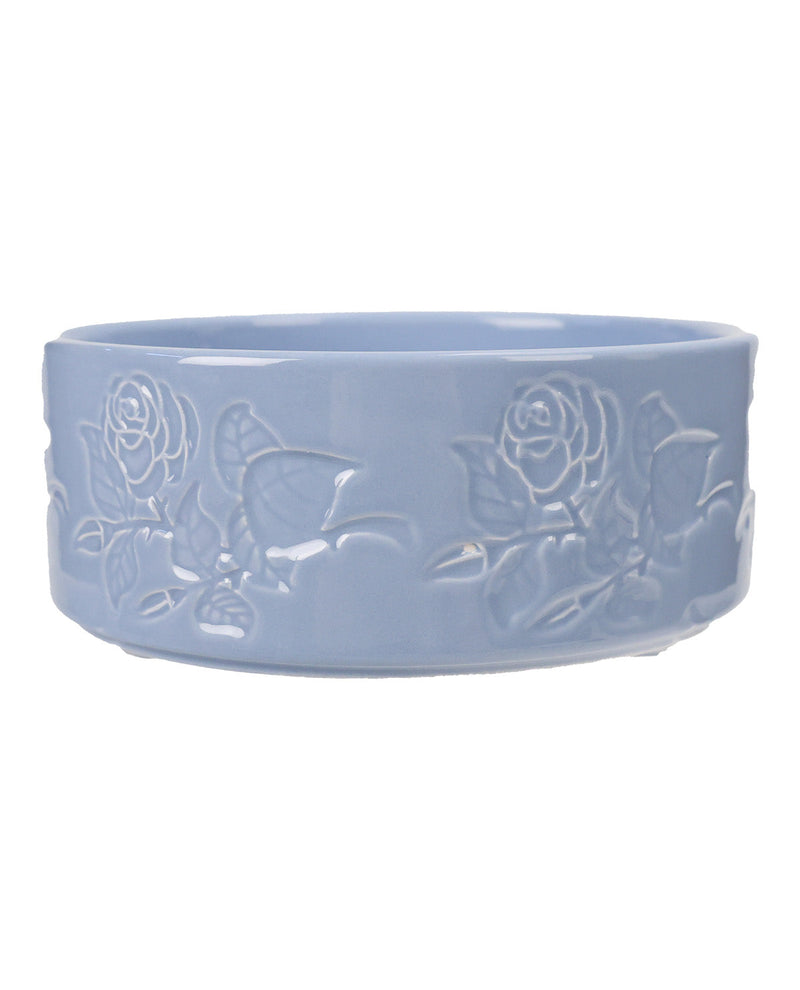 A light blue ceramic bowl featuring embossed rose and leaf patterns on its exterior, shown against a plain white background.