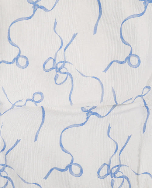 White fabric with a light blue abstract wavy line pattern.