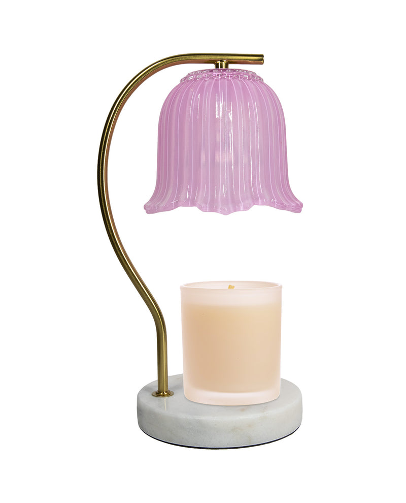 Table lamp with pink glass shade and marble base on a white background