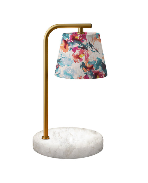 Table lamp with floral shade and marble base on a white background