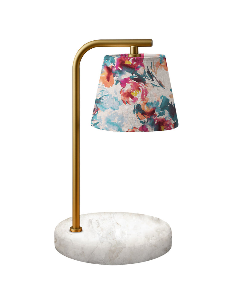Table lamp with floral shade and marble base on a white background