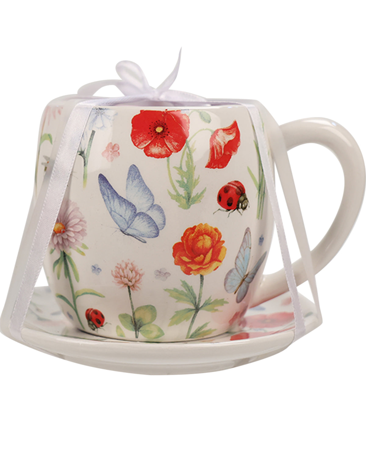 A white ceramic teacup and saucer set decorated with a colorful nature print of red poppies, blue butterflies, ladybugs, and flowers, wrapped in a white satin ribbon.
