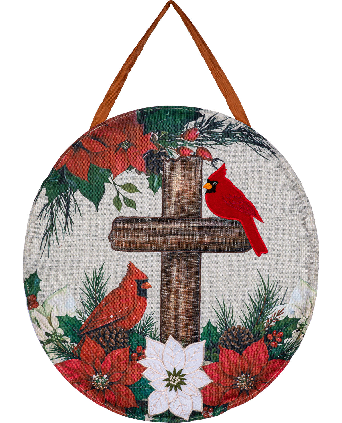 Round hanging holiday wall decor with a printed design featuring two red cardinals, red poinsettias, white poinsettias, pine branches, and a brown cross on a light fabric background, with brown hanging straps.