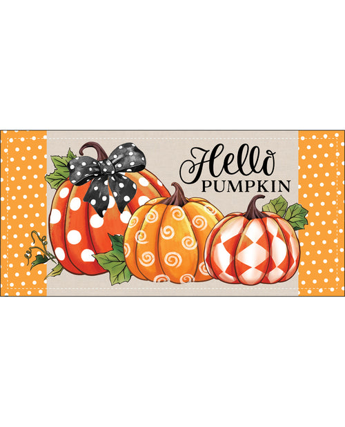 A decorative autumn sign featuring three illustrated pumpkins with orange, white, and orange swirl patterns, green leaves, and a black bow. The sign includes the text 'Hello PUMPKIN' in black script and block lettering, with orange-and-white polka dot side panels on a light beige background.