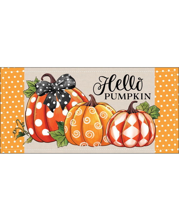 A decorative autumn sign featuring three illustrated pumpkins with orange, white, and orange swirl patterns, green leaves, and a black bow. The sign includes the text 'Hello PUMPKIN' in black script and block lettering, with orange-and-white polka dot side panels on a light beige background.