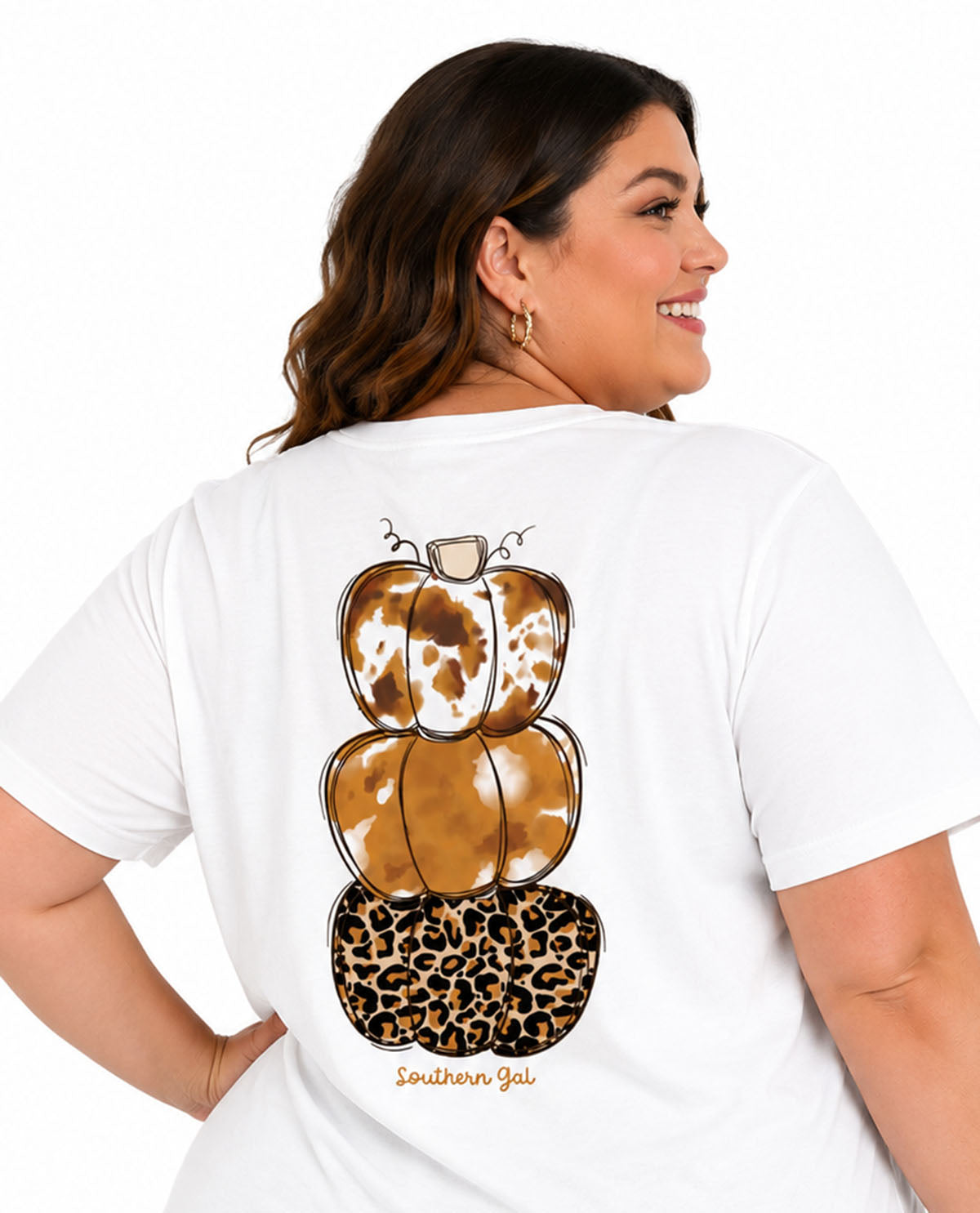 Woman wearing a white t-shirt with a leopard print pumpkin design on the back.