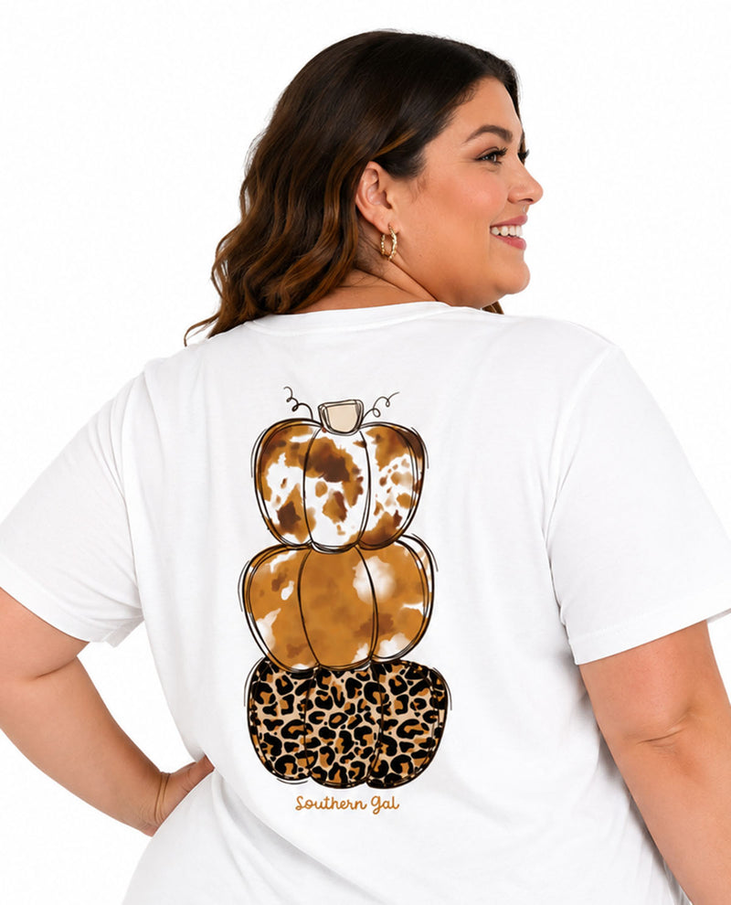 Woman wearing a white t-shirt with a leopard print pumpkin design on the back.