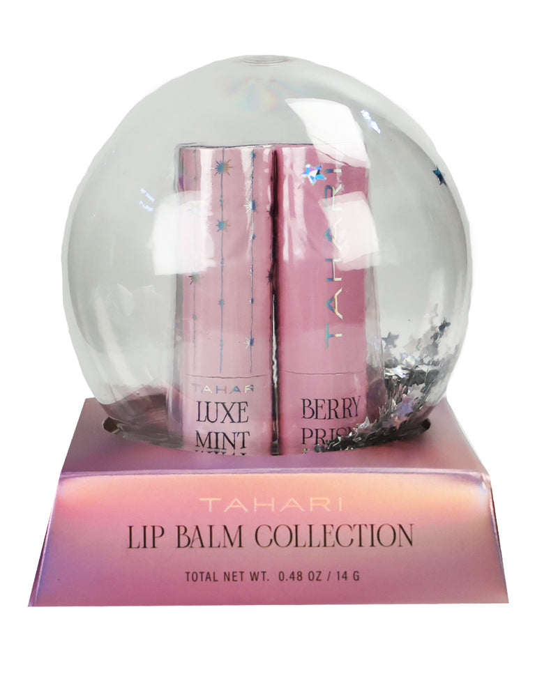 Tahari Luxe Mint and Berry Pick lip balm collection in a clear spherical snow globe display with a pink base box on a white background.