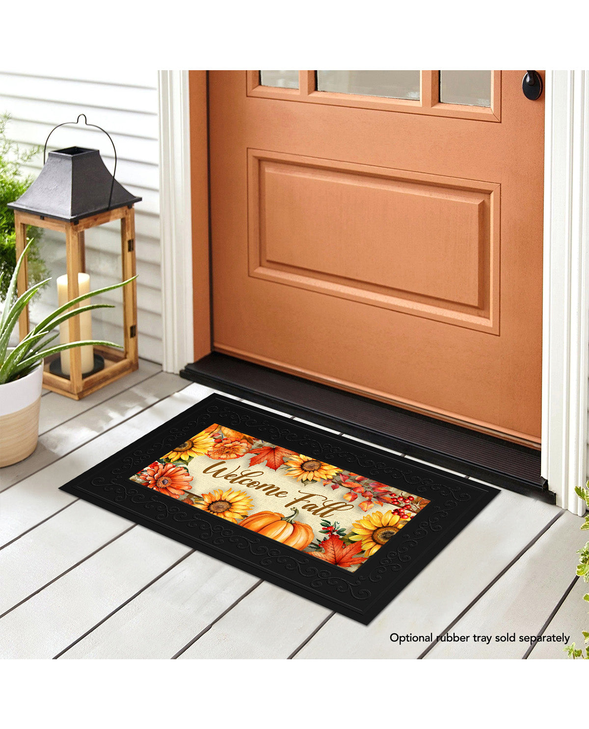 Decorative doormat with autumn design on a wooden floor in front of a door.