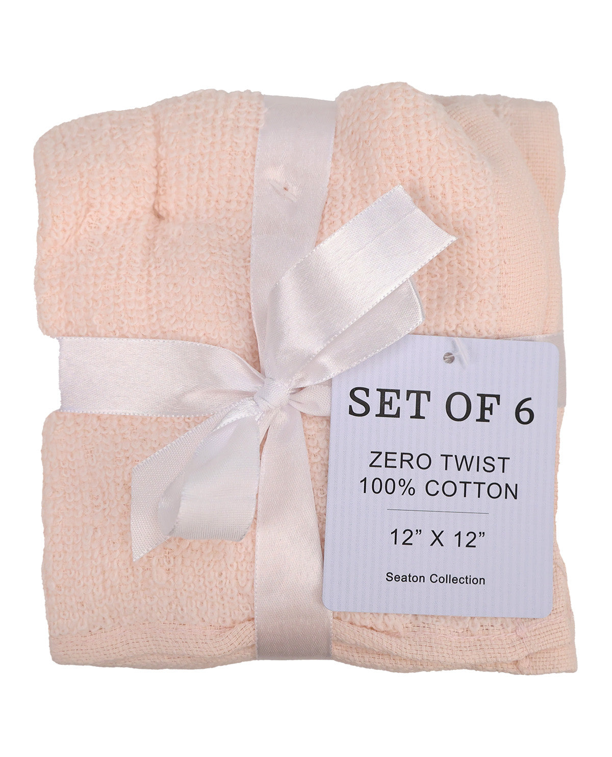 A set of six folded cotton towels in a pale peach-pink color, wrapped with a white satin ribbon and a white paper tag that reads 'SET OF 6 ZERO TWIST 100% COTTON 12" X 12" Seaton Collection'.