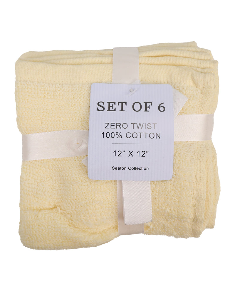 A set of six folded zero twist cotton bath towels in a pale cream color, wrapped with a white ribbon and a white paper tag that reads 'SET OF 6 ZERO TWIST 100% COTTON 12" X 12" Seaton Collection'.