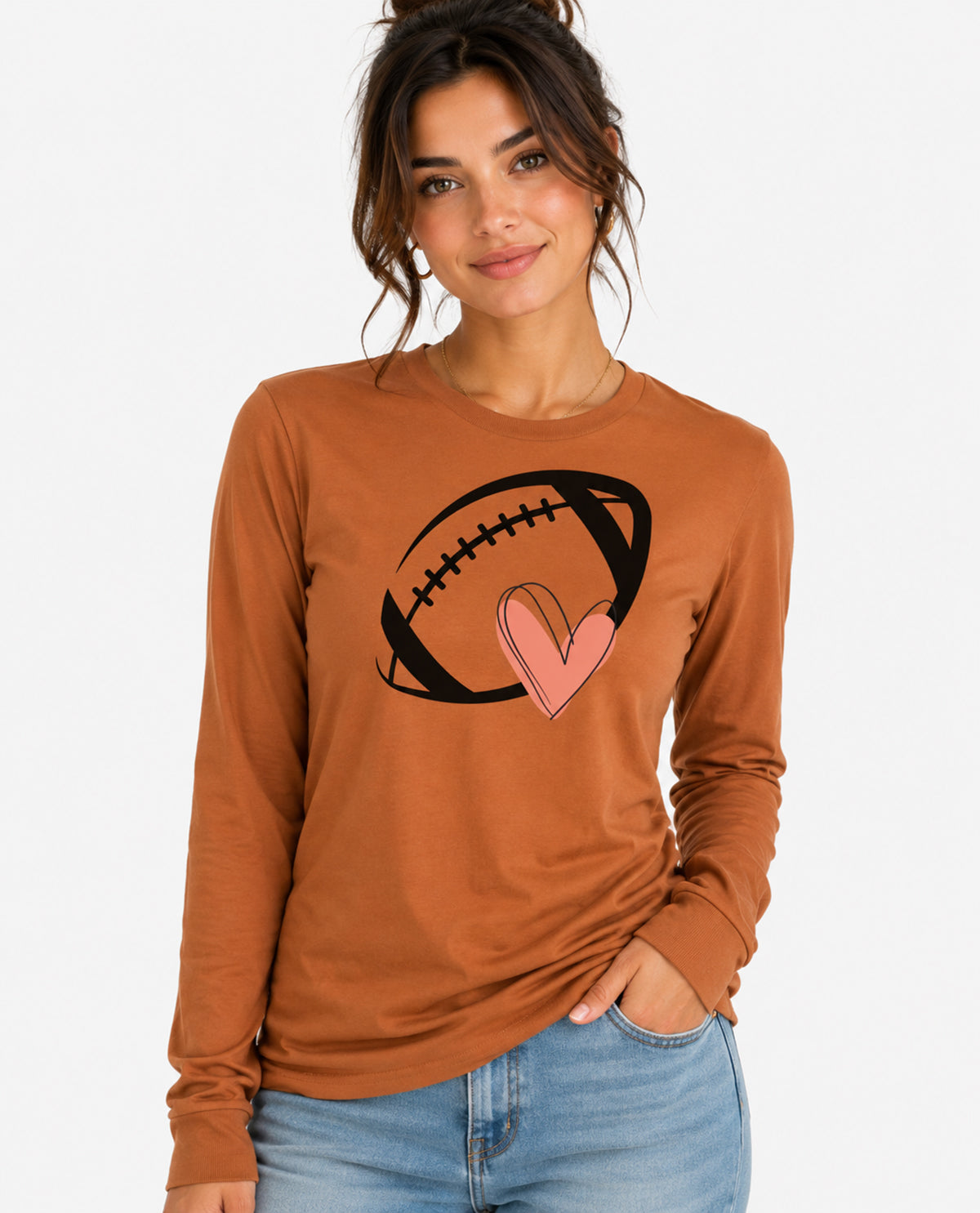 Woman wearing a brown long-sleeve shirt with a football and heart design on a white background