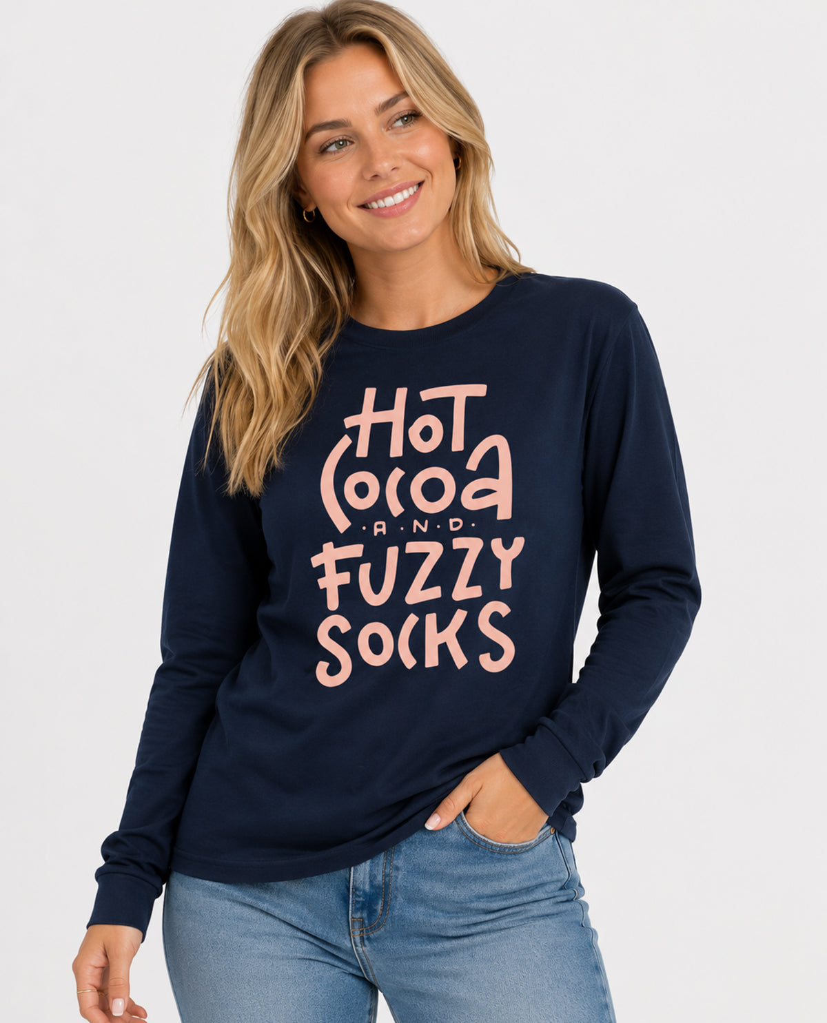 Woman wearing a navy sweatshirt with pink text 'Hot Cocoa & Fuzzy Socks' on a white background