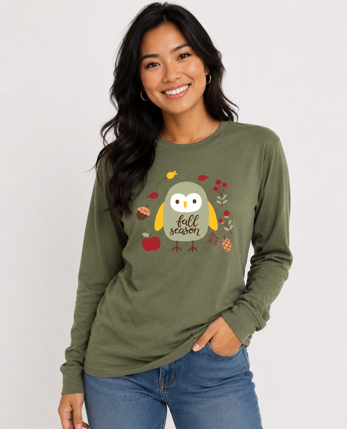 Woman wearing a green long-sleeve shirt with a owl graphic and 'fall season' text on a white background