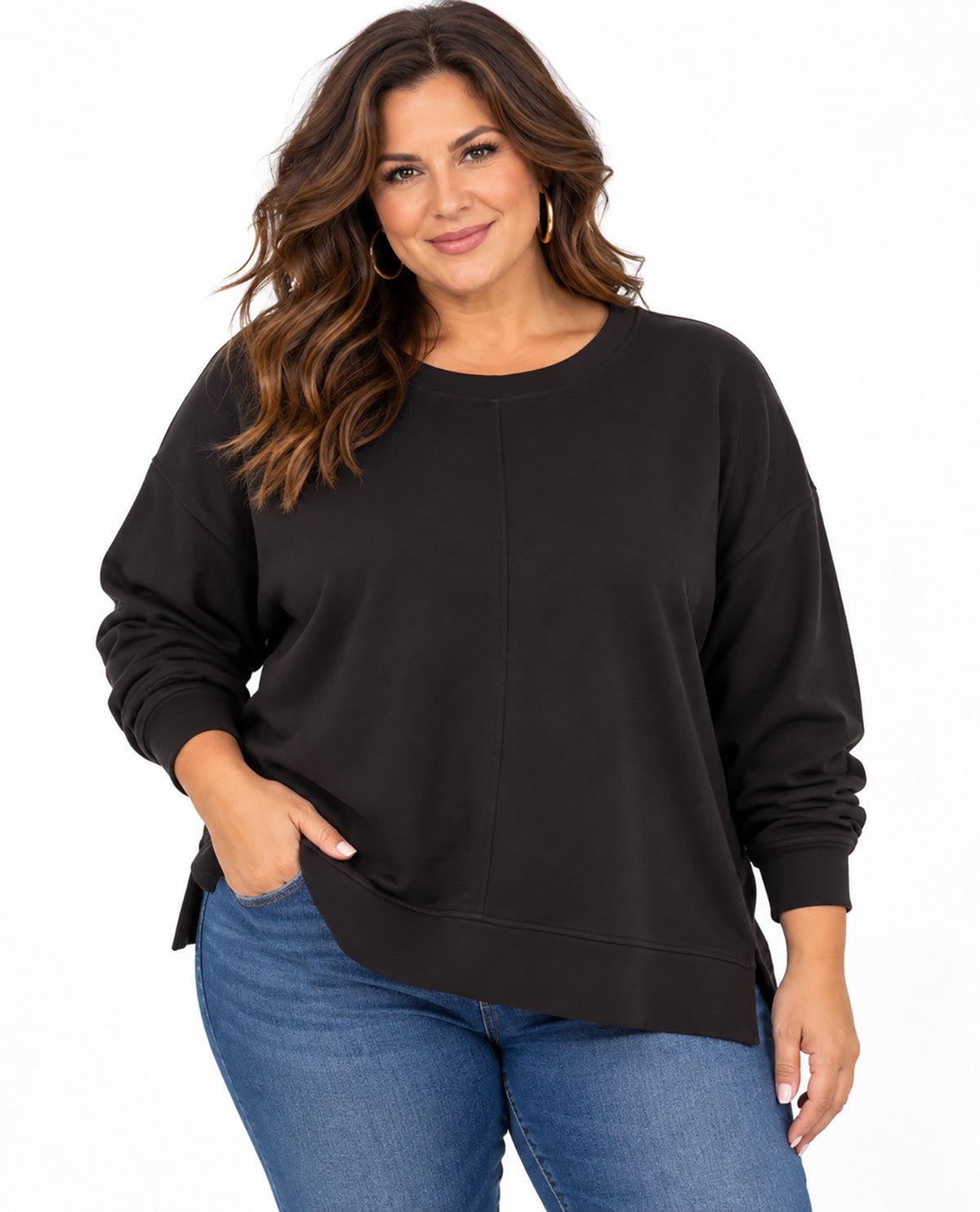 A woman wearing a black long-sleeve crewneck sweatshirt and blue jeans, standing against a plain white background.