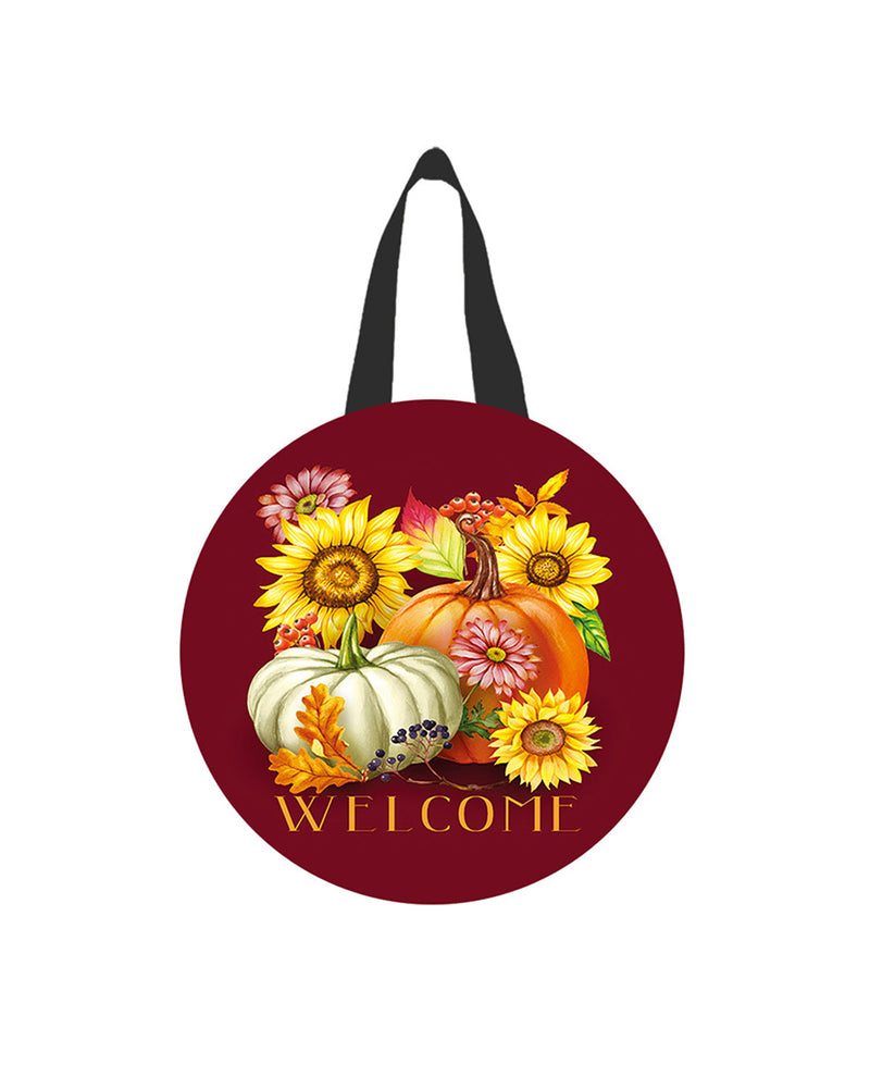 Round decorative item with pumpkins, flowers, and 'Welcome' text on a red background