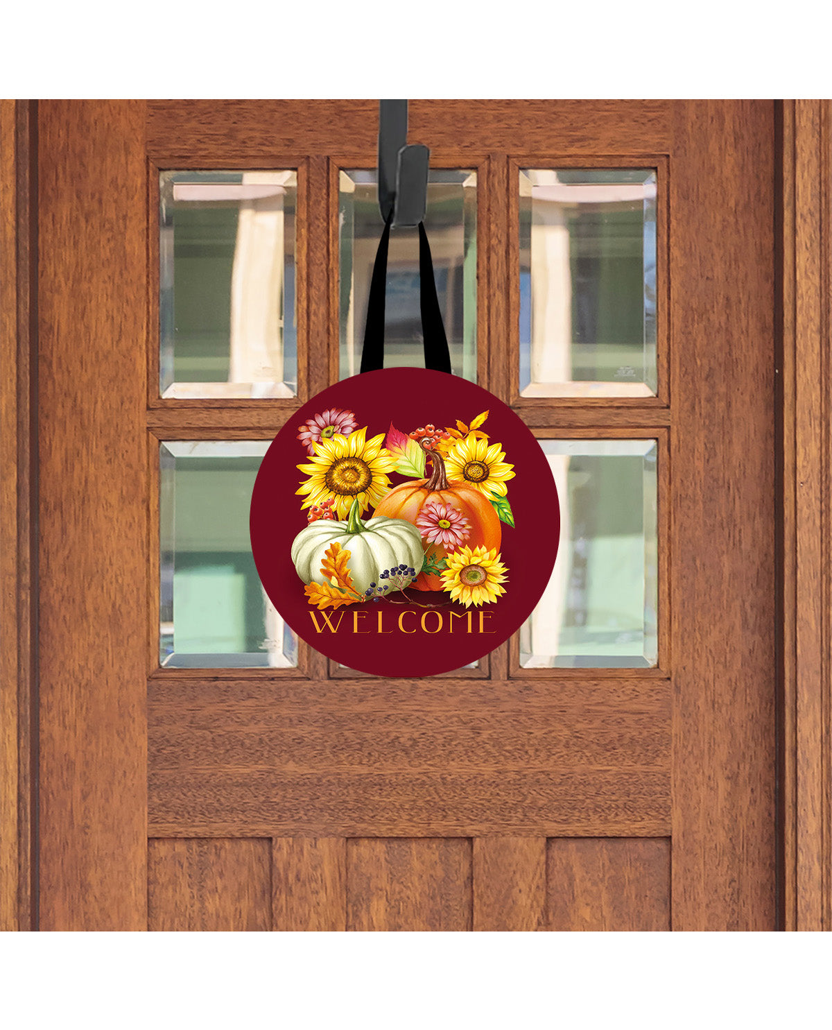 Decorative door hanger with pumpkins and flowers on a wooden door