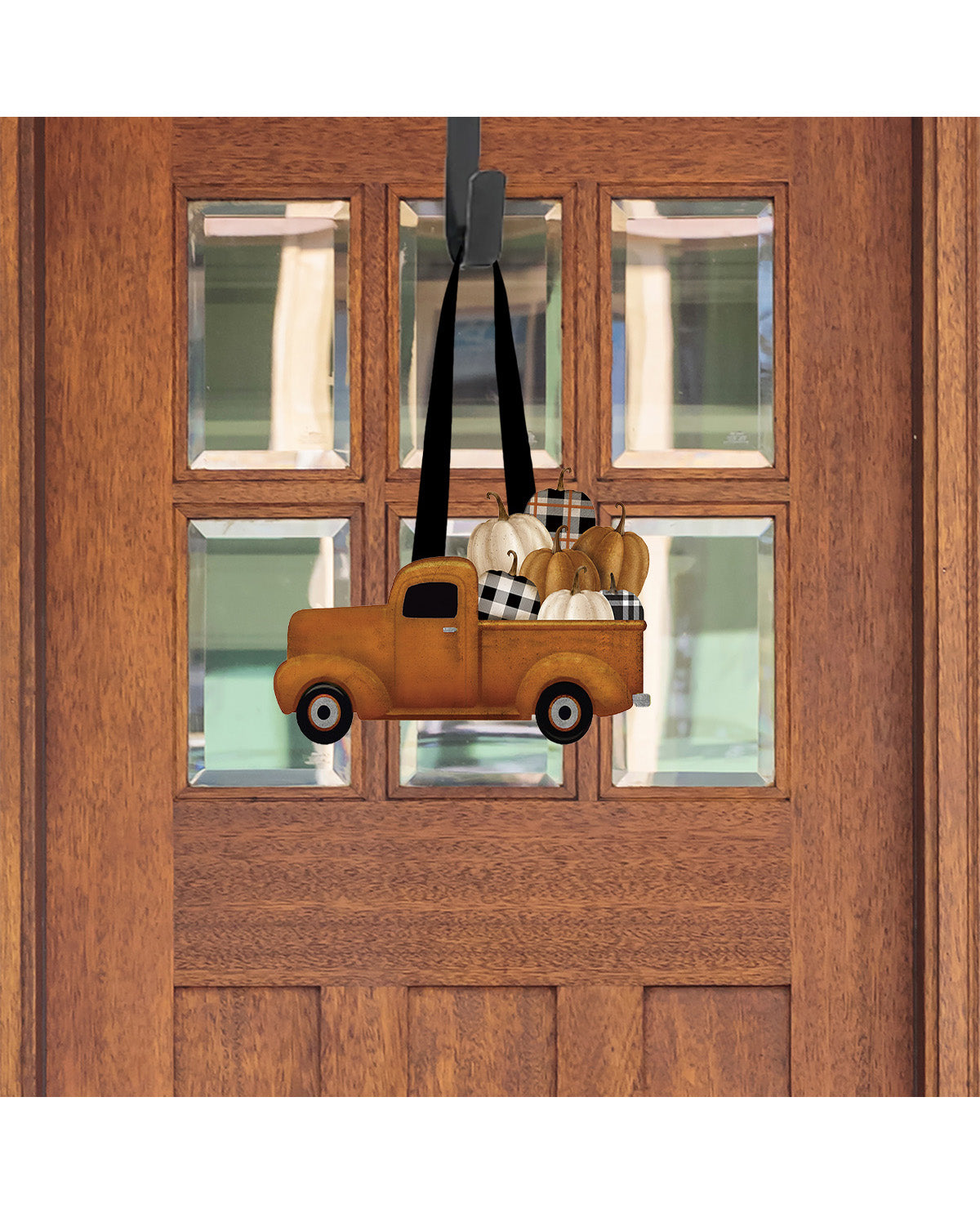 Decorative door hanger of a vintage truck with items on a wooden door.