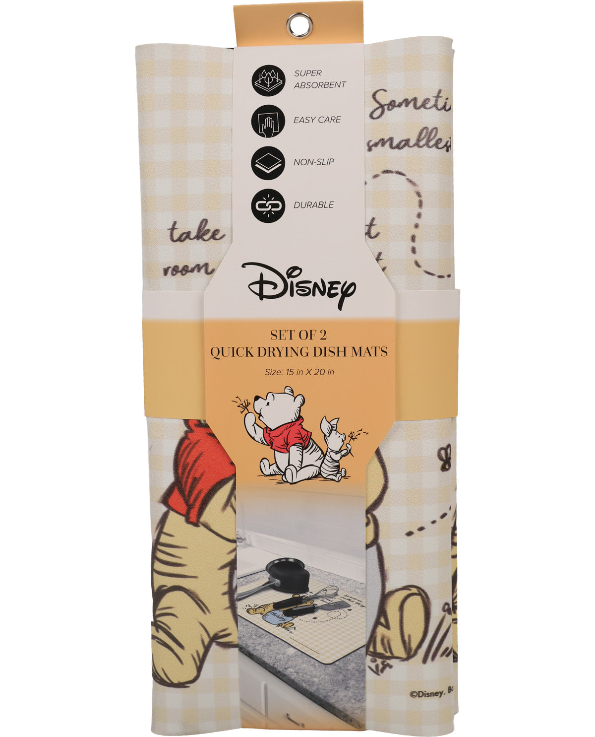 A packaged set of two Disney quick drying dish mats featuring Winnie the Pooh illustrations and a cream-and-tan gingham pattern, shown on a white background.