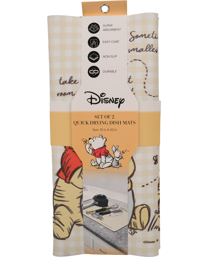 A packaged set of two Disney quick drying dish mats featuring Winnie the Pooh illustrations and a cream-and-tan gingham pattern, shown on a white background.