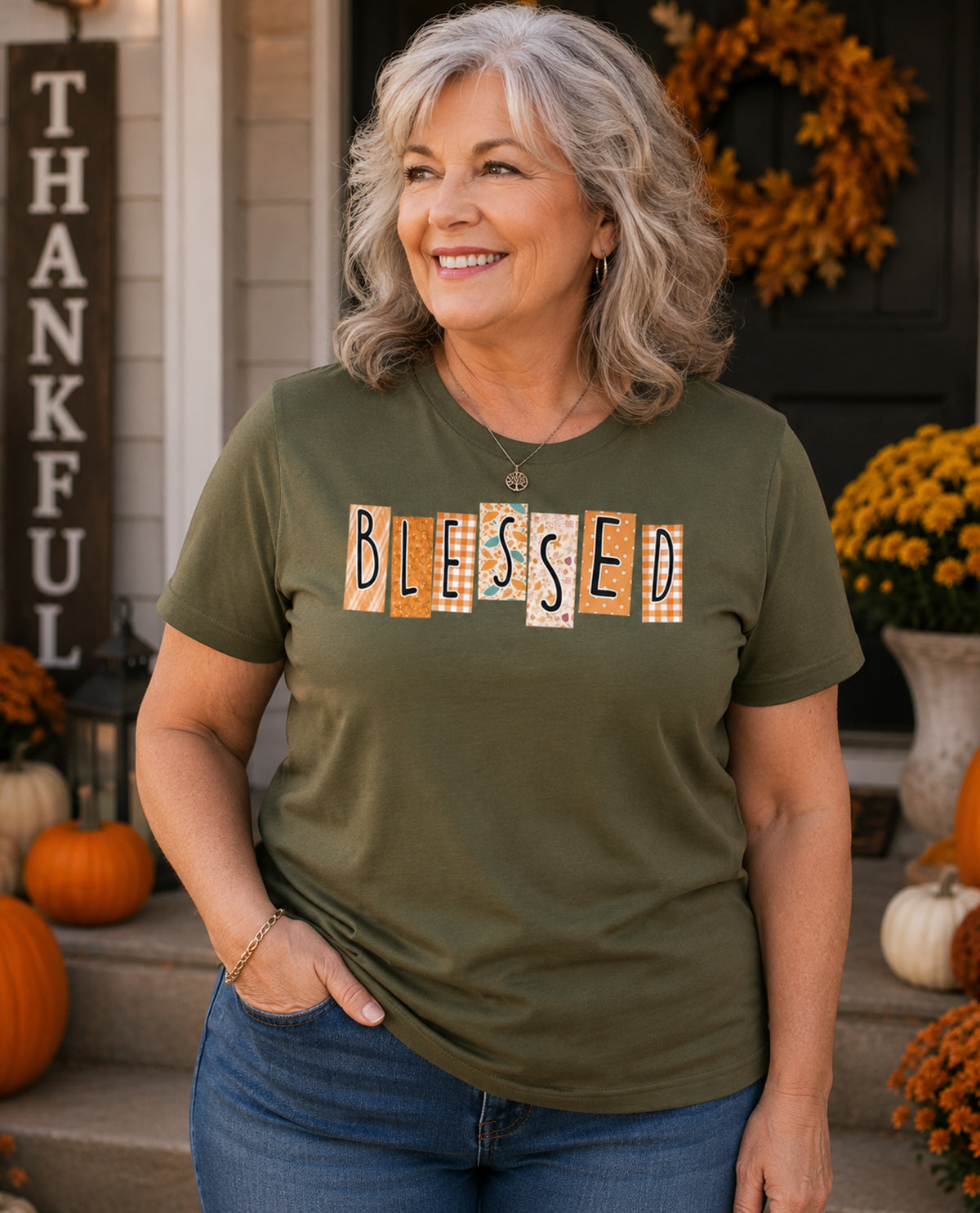 Woman wearing a green t-shirt with 'BLESSED' printed on it, standing in front of a decorated porch.