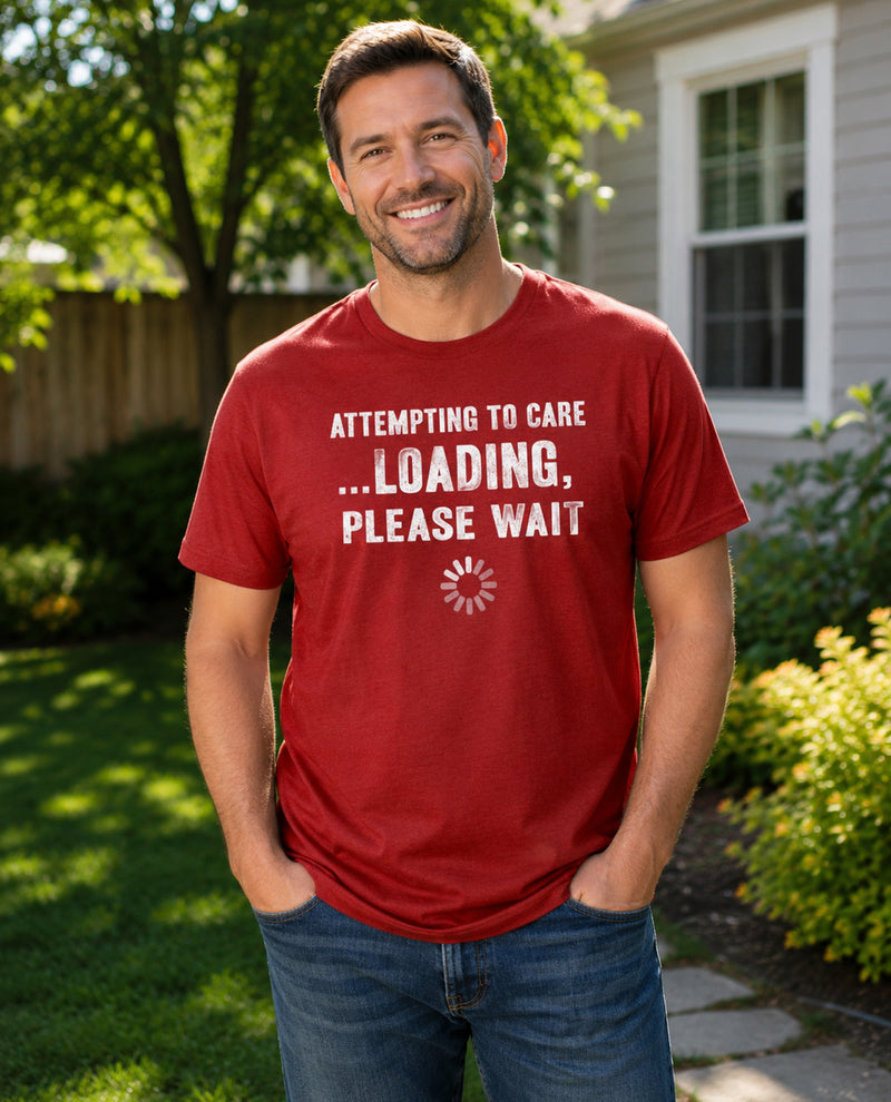 Man wearing a red t-shirt with humorous text in a garden setting