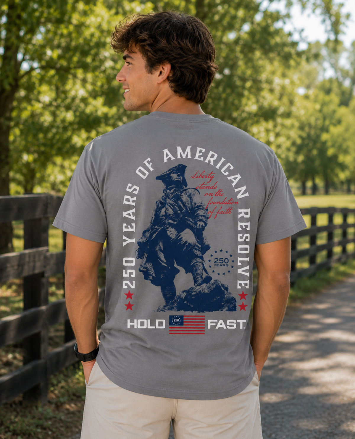 Man wearing a gray t-shirt with a graphic design outdoors