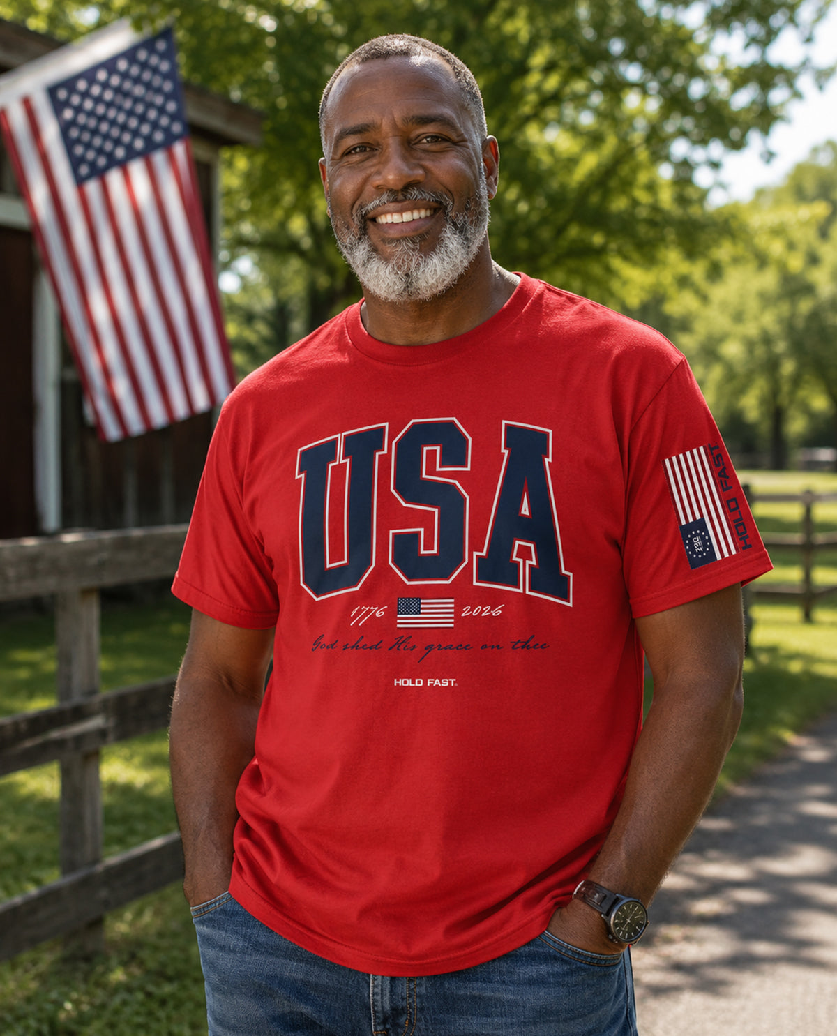 Man wearing a red 'USA' t-shirt with an American flag in the background