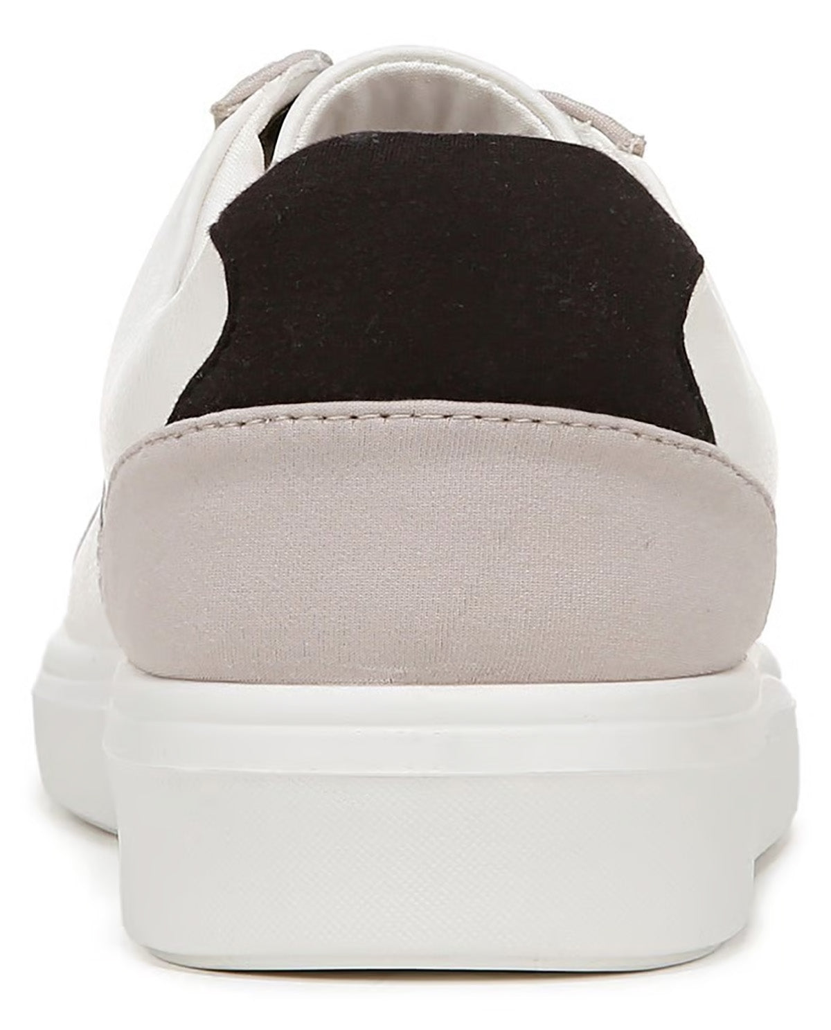 A close-up rear view of a low-top sneaker with a white leather upper, a black suede heel panel, and a light beige canvas heel counter on a white sole.