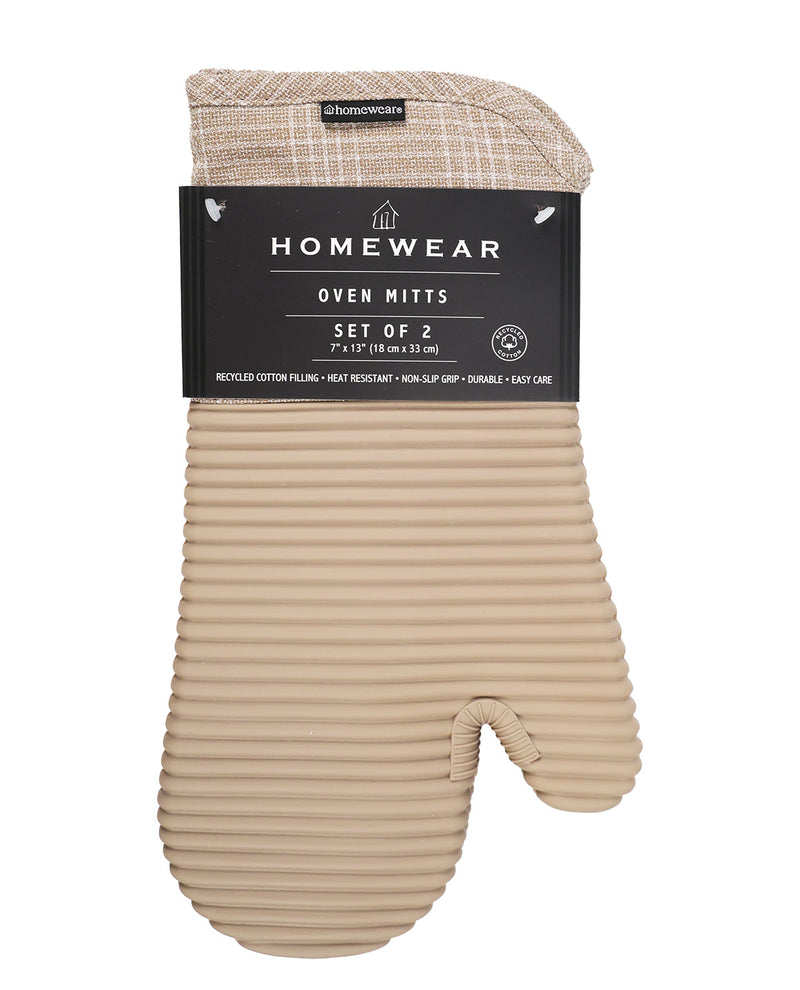 A set of two oven mitts in a ribbed beige cotton fabric, packaged with a black paper header card labeled 'Homewear'.