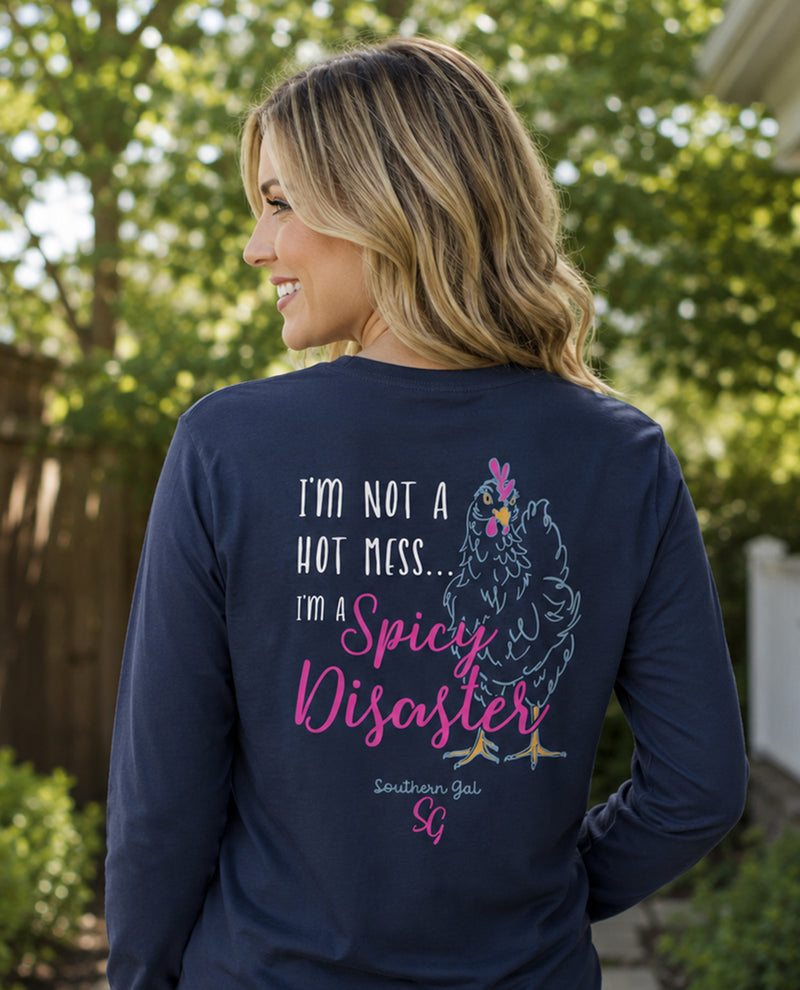 Woman wearing a navy blue shirt with a graphic and text, standing outdoors.