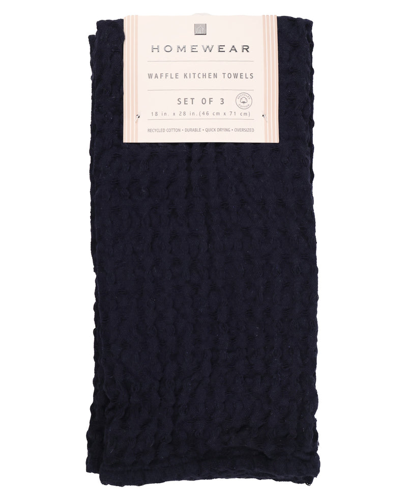 A folded set of three dark navy blue waffle kitchen towels with a cream paper label that reads 'HOMEWEAR'.