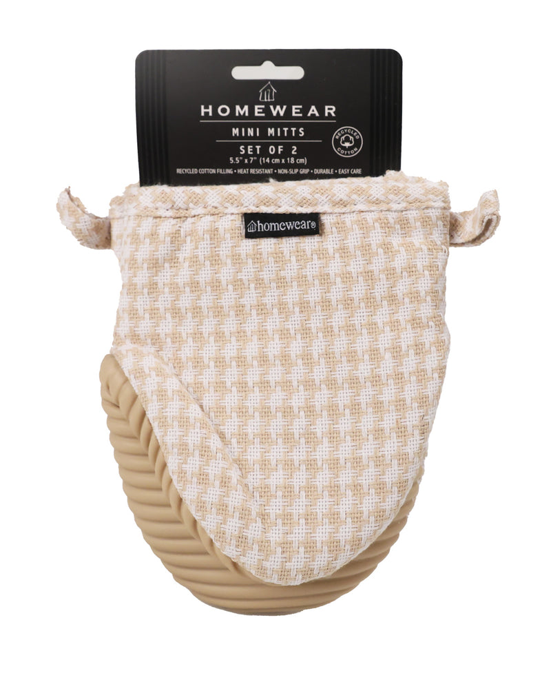 A set of two baby mini mittens by Homewear, featuring a beige and cream checkered fabric top with a soft tan braided mitt underneath, shown with its black retail packaging header card on a white background.