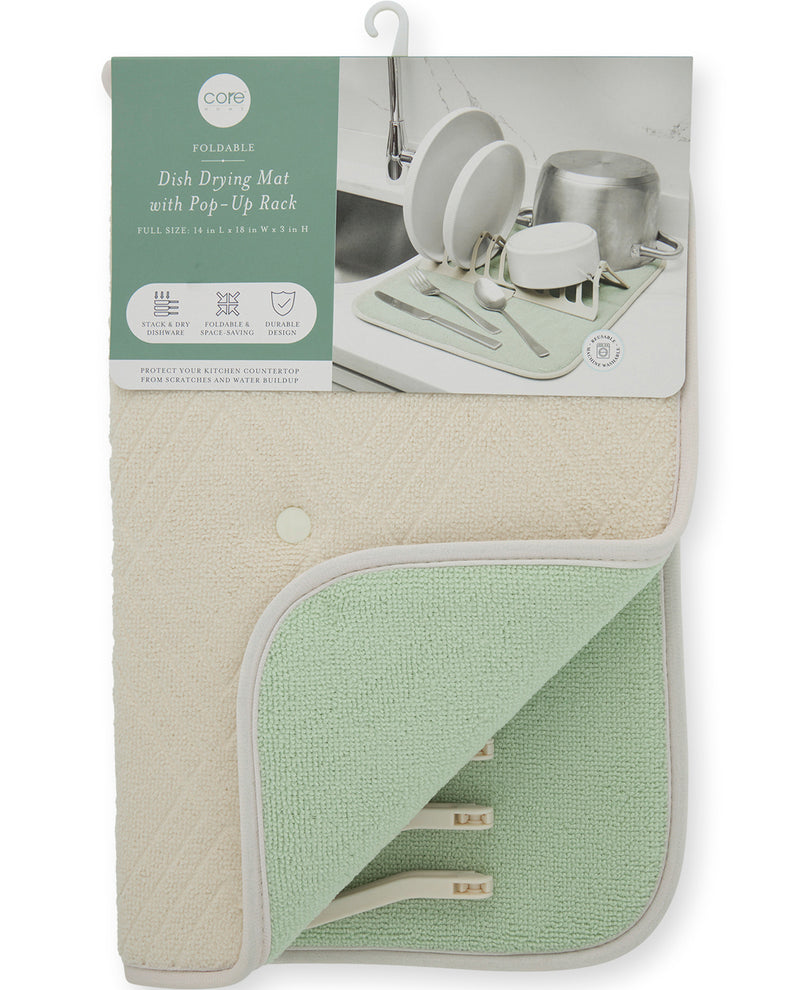 A packaged dish drying mat with a pop-up rack, shown hanging against a white background. The product is folded to reveal two main colors: a warm cream/beige side and a light mint green side.