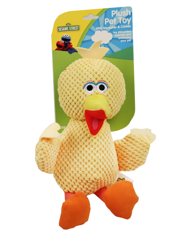 Sesame Street Plush Pet Toy in the form of Big Bird, made from a yellow knitted mesh material with orange feet, a red beak, and blue eyes, still attached to its green and yellow retail card.