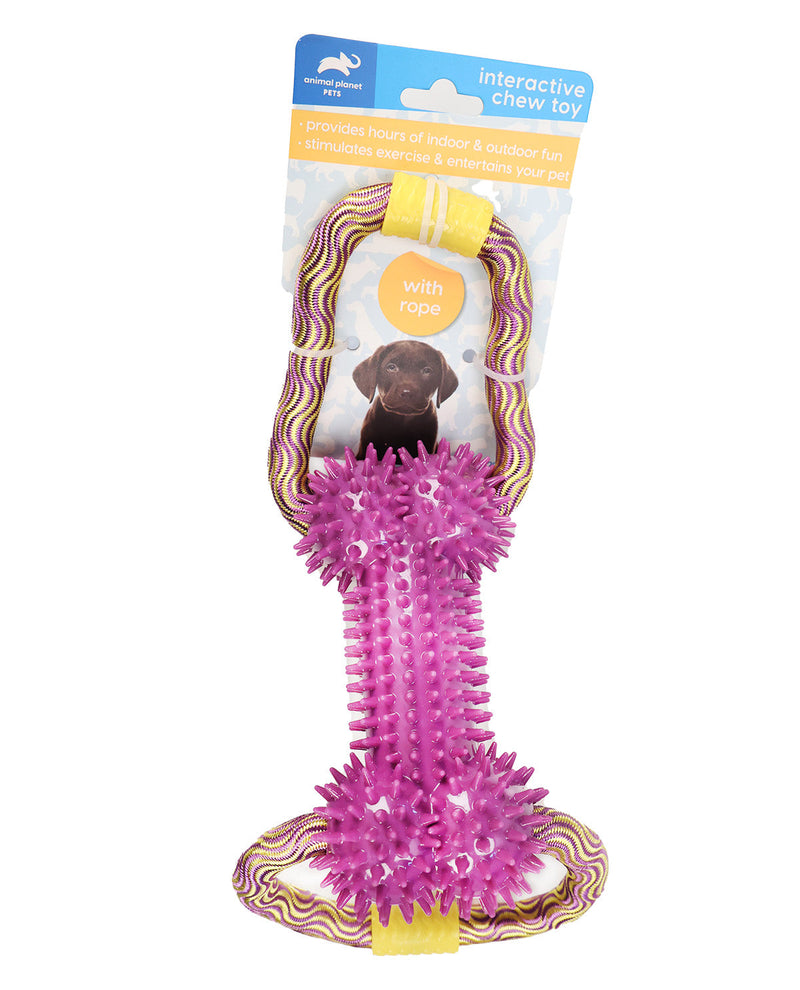 A packaged pet toy on a white background. The product is an interactive chew toy for dogs, featuring a bright pink spiky center connected to a wavy pink, yellow, and brown strap, with a cardboard header card at the top.