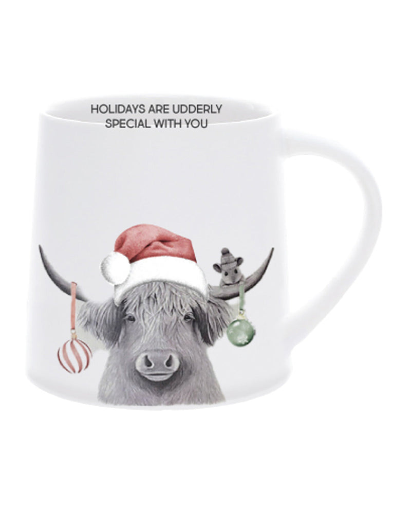 Mug with a design of a cow wearing a Santa hat and text 'Holidays are udderly special with you' on a white background.
