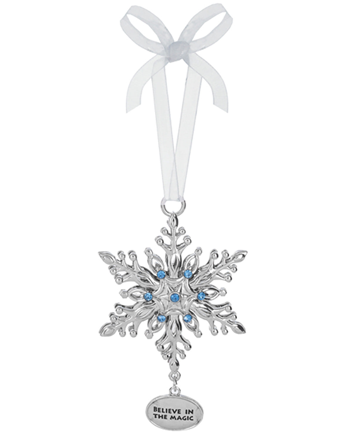 A silver snowflake Christmas ornament with small blue rhinestones in the center, hanging from a white ribbon bow. A small oval tag at the bottom reads 'BELIEVE IN THE MAGIC'.