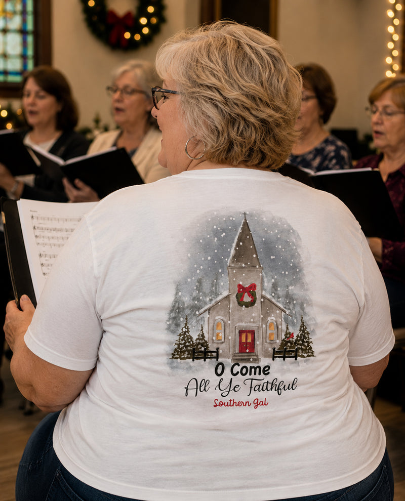 Person wearing a white t-shirt with a church graphic and text, standing in front of a choir.