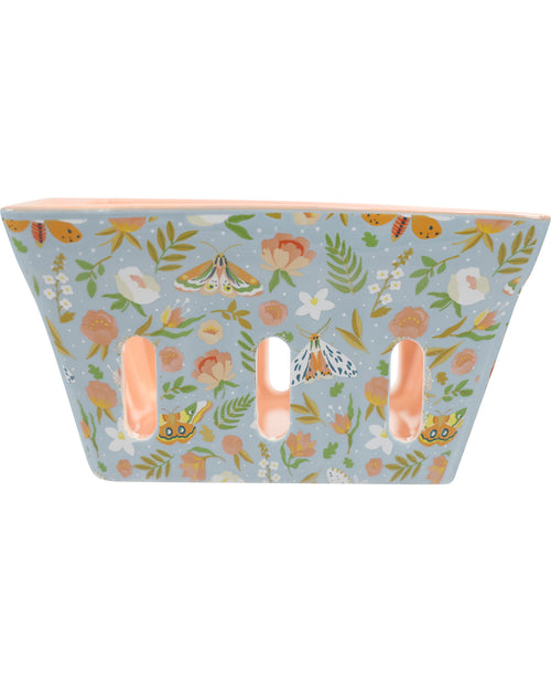 A rectangular ceramic planter with three vertical slits, featuring a light blue background decorated with a whimsical pattern of butterflies, moths, bees, and flowers in soft peach, orange, green, and white tones.