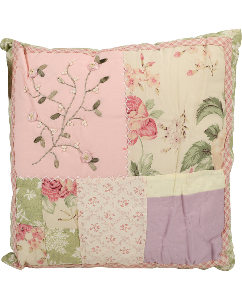 A square patchwork decorative pillow featuring a vintage floral and botanical design in soft pastel colors, including pink, lavender, green, and cream, with embroidered details and a gingham border.
