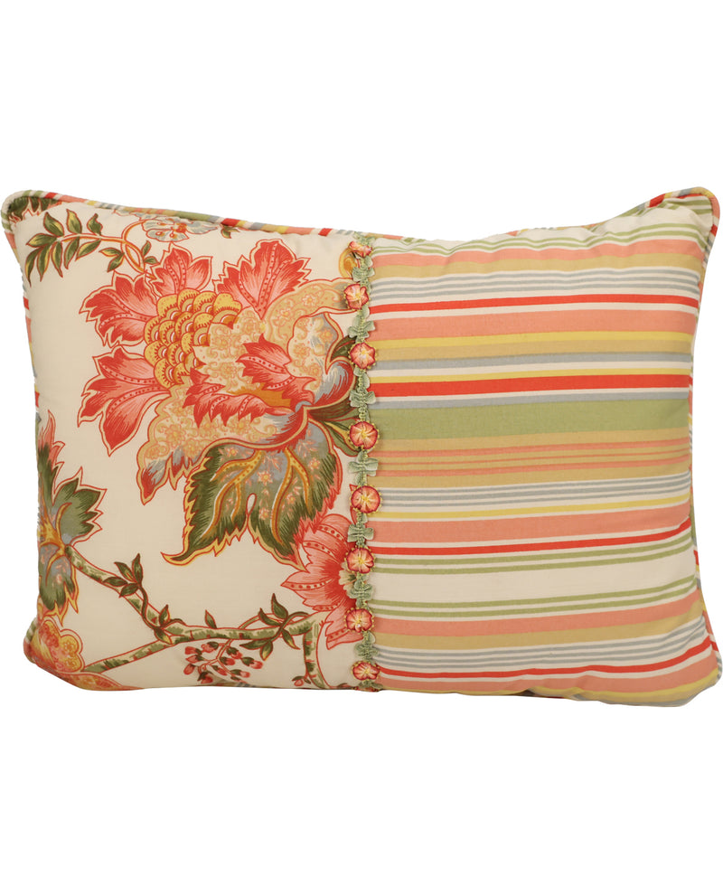 A square decorative throw pillow featuring a split design: one half displays a large floral print with red, orange, and green blossoms on a cream background, and the other half features vertical stripes in orange, yellow, green, and blue on a cream base.